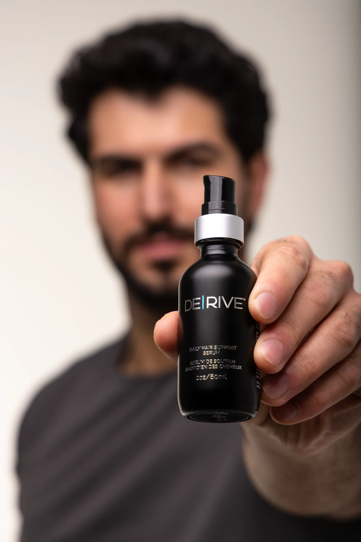 Woman with long, healthy dark hair representing the fuller-looking results DE|RIVE is designed to support